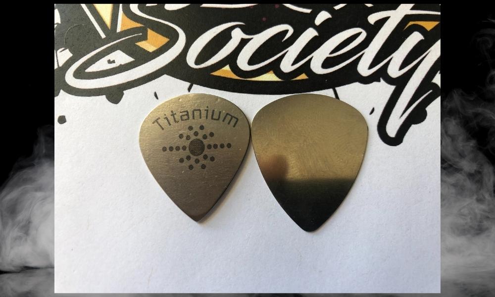 A titanium and steel guitar pick 